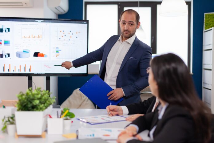 Successful team leader briefing pointing explaining project Management Buyout